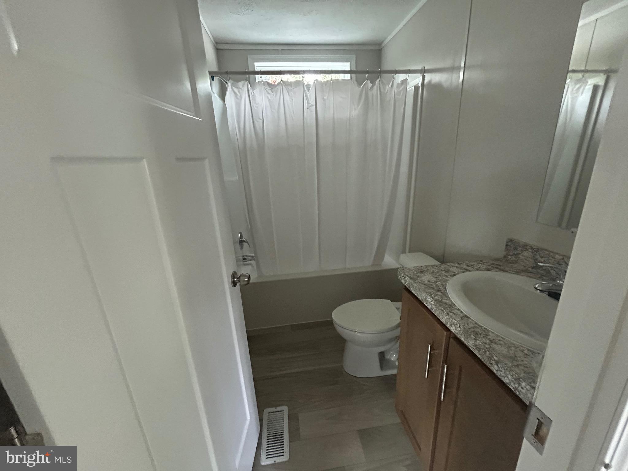 2501 Tilton Road, Unit 312 Egg Harbor Township, NJ 08234 - Photo 15 of 18 a bathroom with a granite countertop sink toilet and shower
