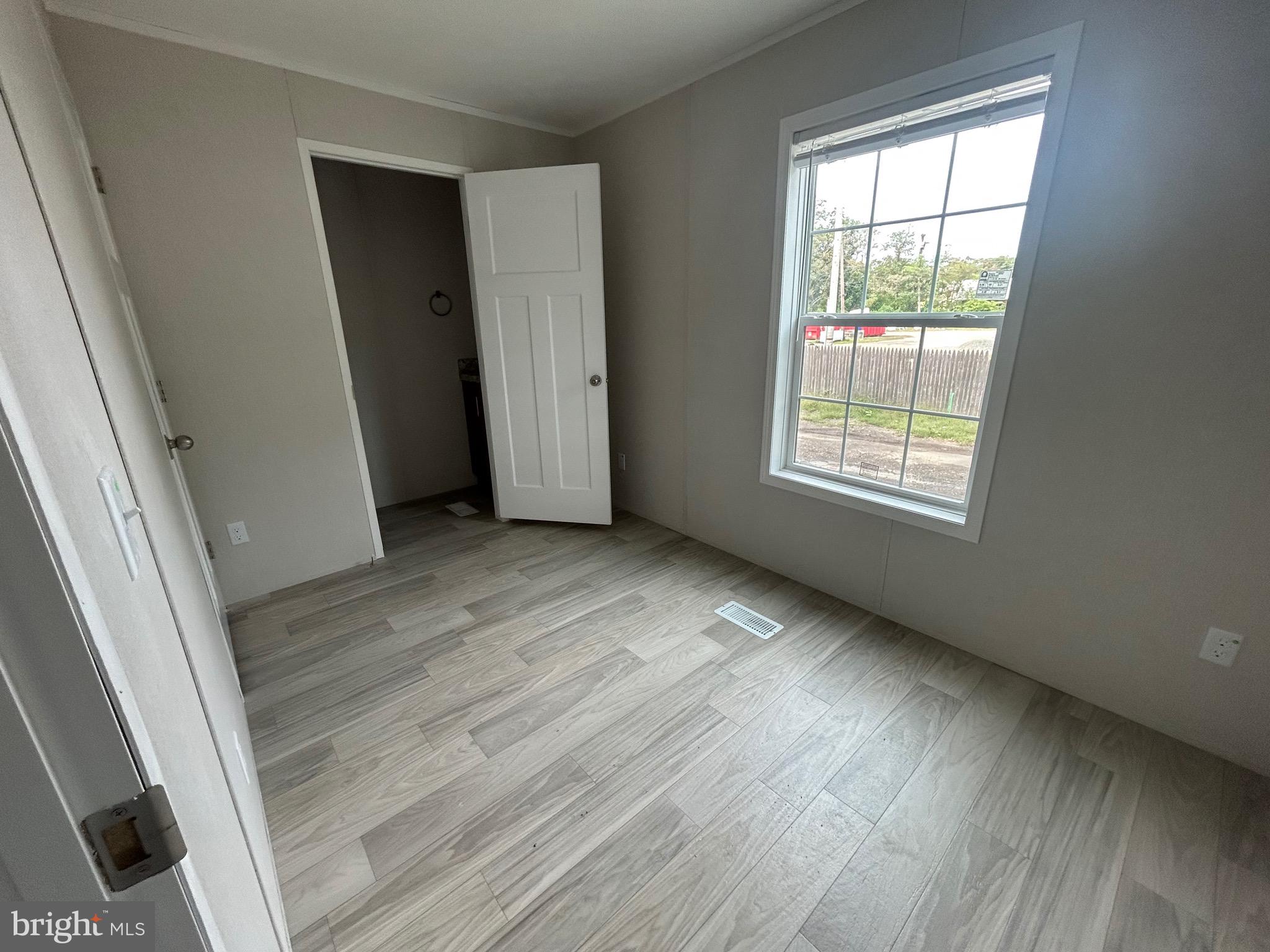 2501 Tilton Road, Unit 312 Egg Harbor Township, NJ 08234 - Photo 16 of 18 an empty room with wooden floor and windows
