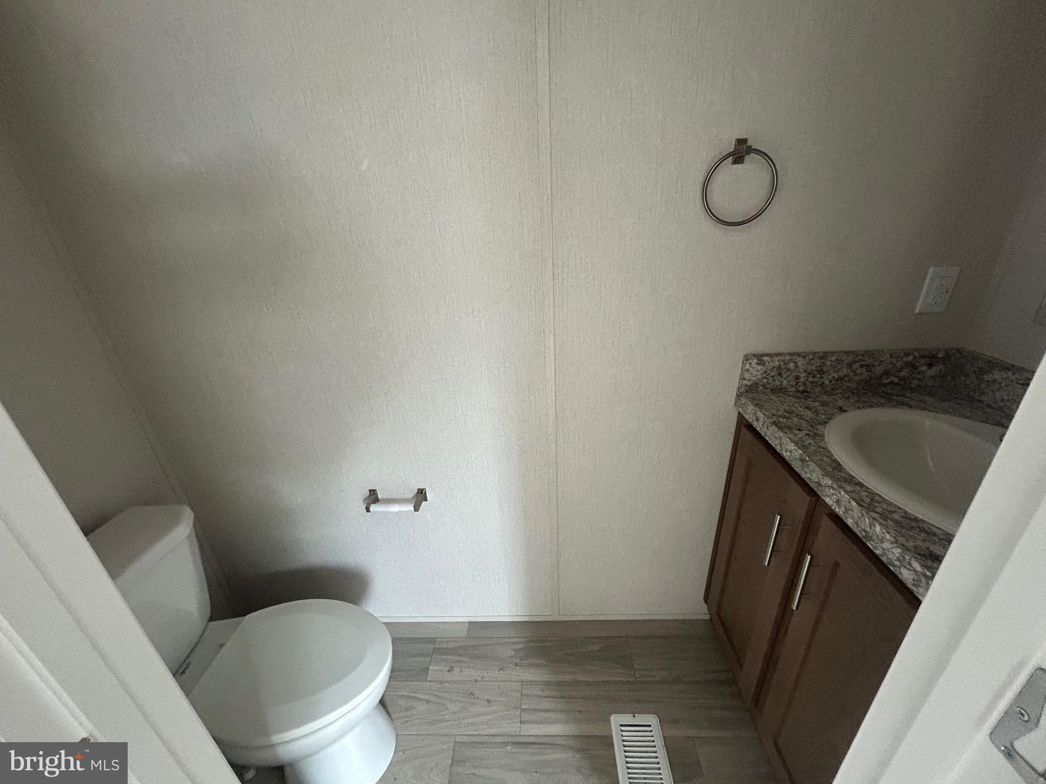 2501 Tilton Road, Unit 312 Egg Harbor Township, NJ 08234 - Photo 17 of 18 a bathroom with a sink toilet and vanity