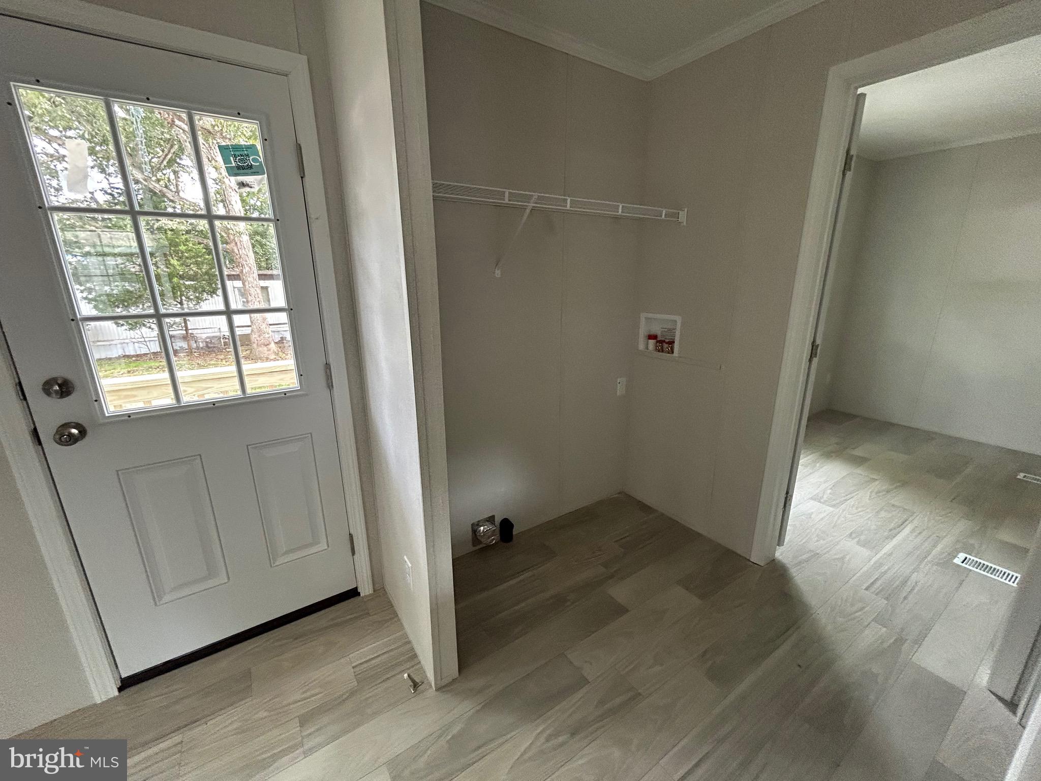 2501 Tilton Road, Unit 312 Egg Harbor Township, NJ 08234 - Photo 18 of 18 an empty room with wooden floor cabinet and windows