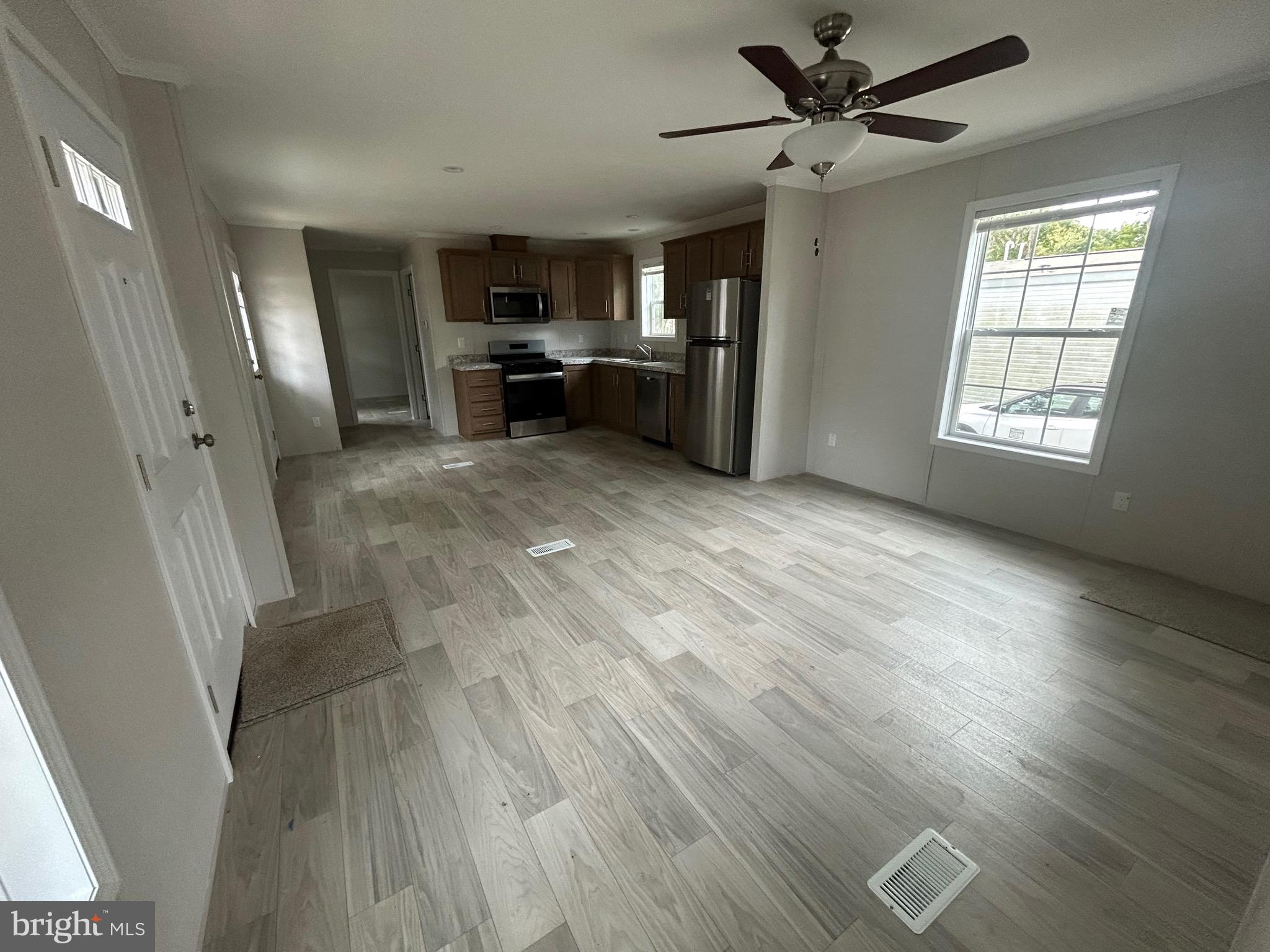 2501 Tilton Road, Unit 312 Egg Harbor Township, NJ 08234 - Photo 5 of 18 a view of a livingroom with furniture a ceiling fan and wooden floor