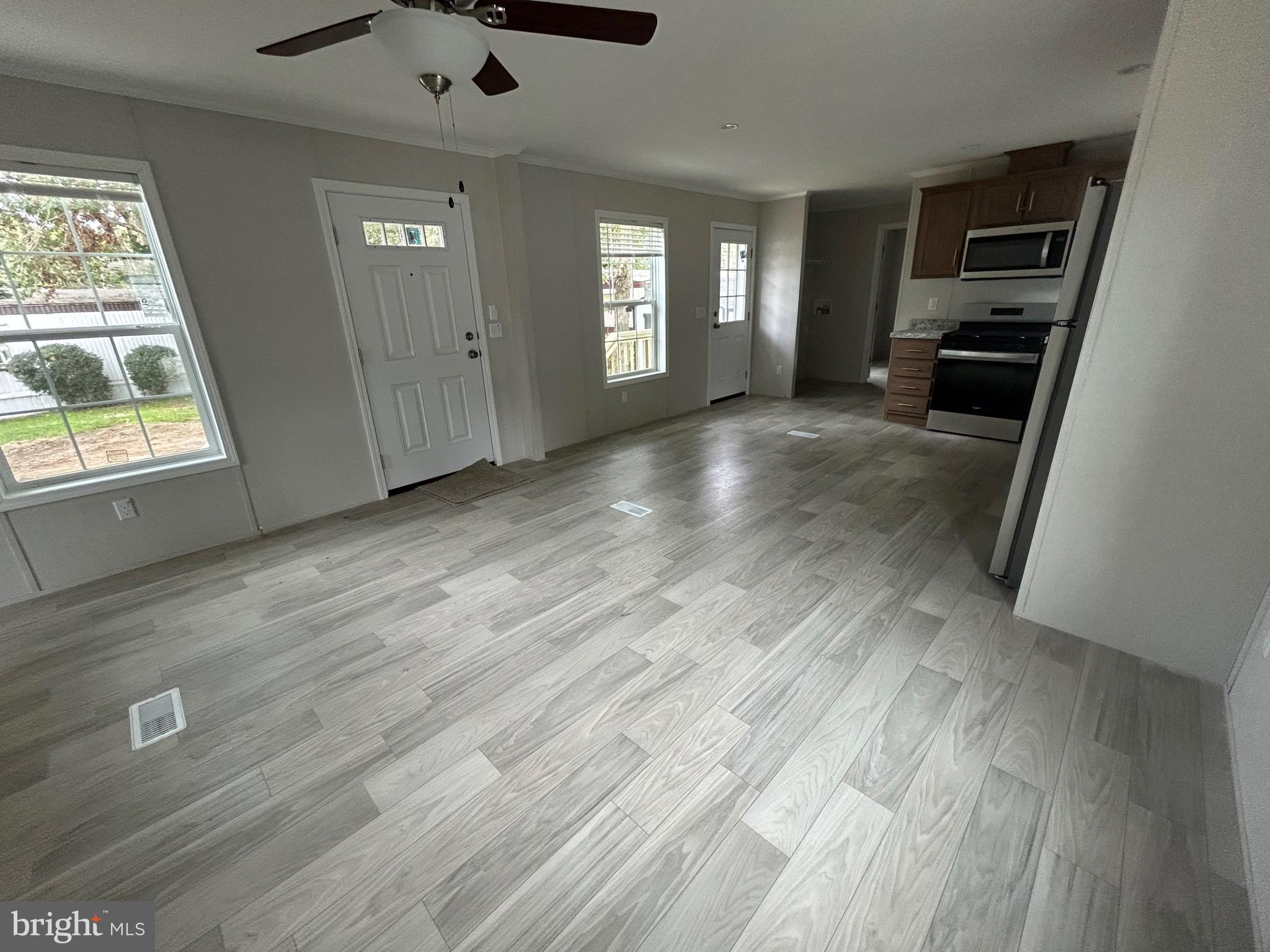 2501 Tilton Road, Unit 312 Egg Harbor Township, NJ 08234 - Photo 6 of 18 wooden floor in an empty room with a window