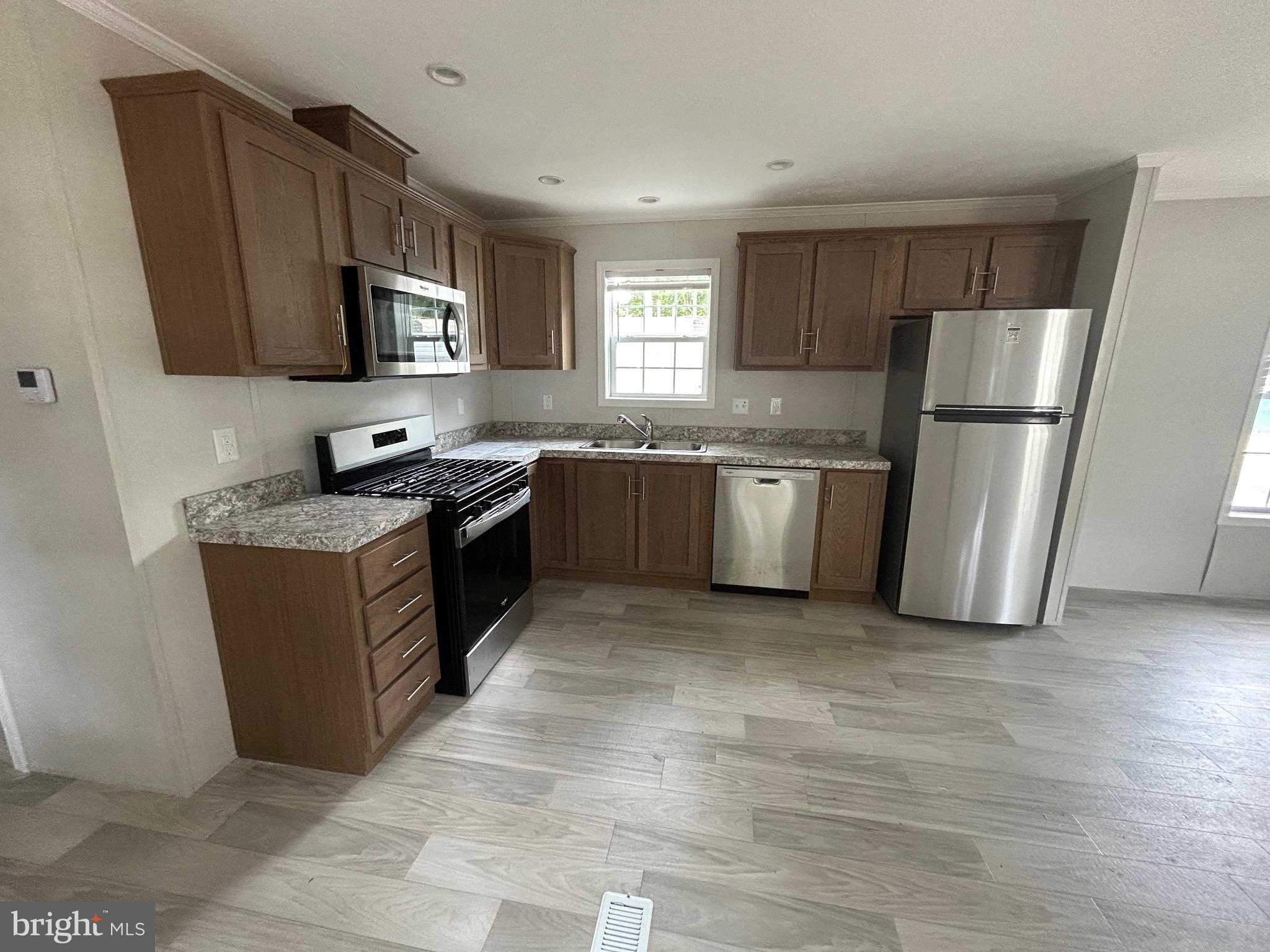 2501 Tilton Road, Unit 312 Egg Harbor Township, NJ 08234 - Photo 8 of 18 a kitchen with stainless steel appliances granite countertop a stove top oven a refrigerator a sink and dishwasher