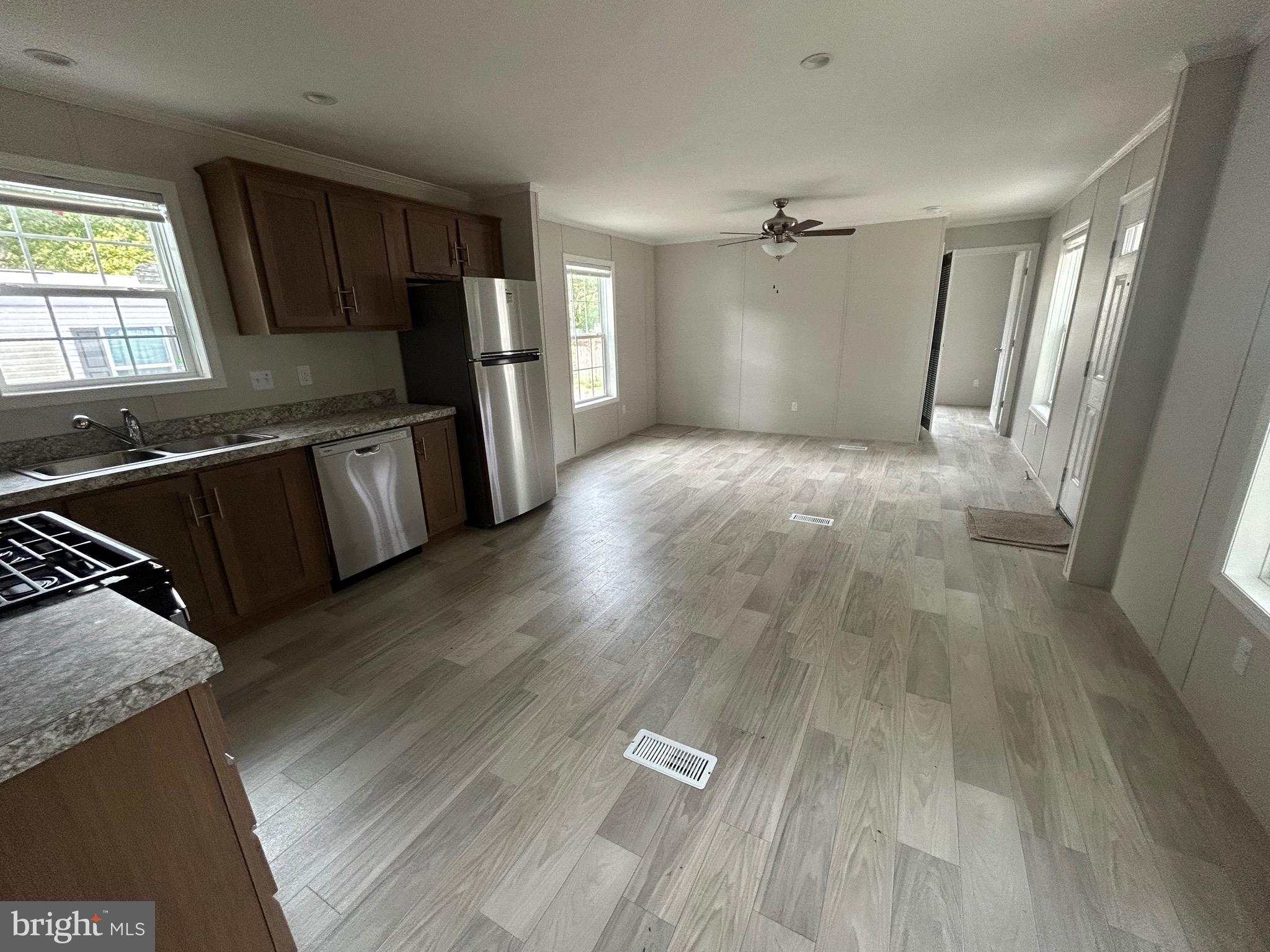 2501 Tilton Road, Unit 312 Egg Harbor Township, NJ 08234 - Photo 10 of 18 a view of a kitchen with wooden floor and electronic appliances