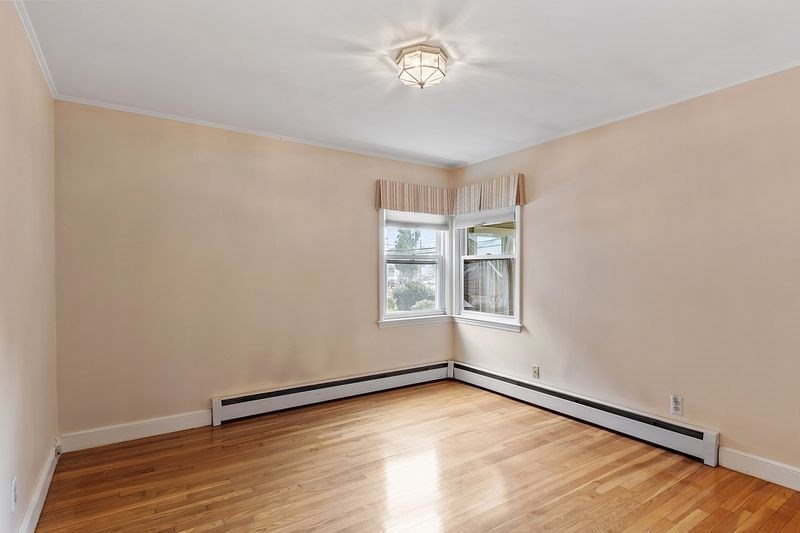 68 Spring Road Nahant, MA 01908 - Photo 12 of 23 an empty room with wooden floor and windows