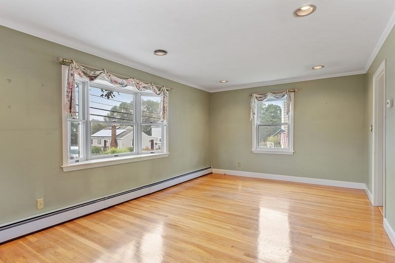 68 Spring Road Nahant, MA 01908 - Photo 4 of 23 a view of an empty room with wooden floor and a window