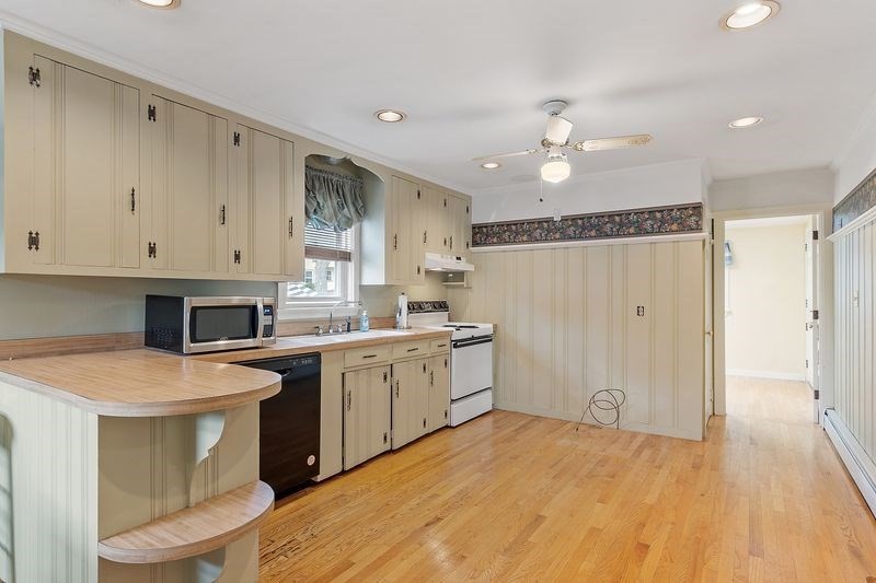 68 Spring Road Nahant, MA 01908 - Photo 9 of 23 a kitchen with a sink stove and cabinets