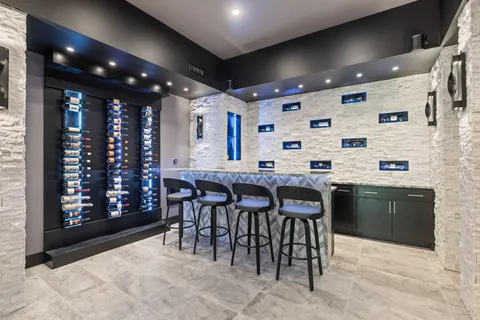 a kitchen with granite countertop a stove a sink a dining table and chairs