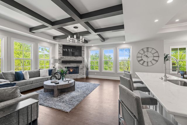 a living room with fireplace furniture and a large window
