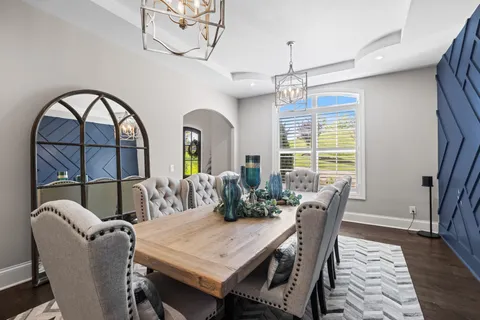 a spacious bedroom with a bed and a flat screen television