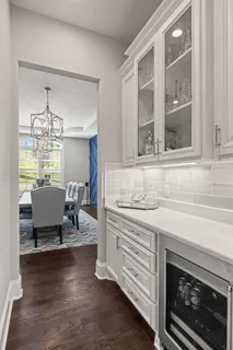a large white kitchen with a large tub