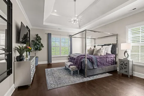 a view of a dining room with furniture wooden floor and a chandelier