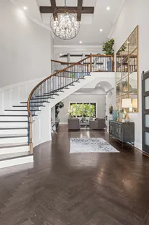 a view of white house with a yard and potted plants