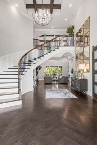 a view of white house with a yard and potted plants
