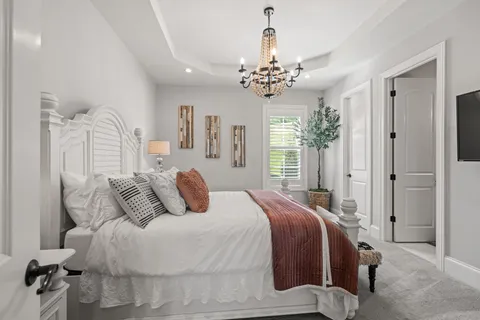 a bed room with furniture and a chandelier