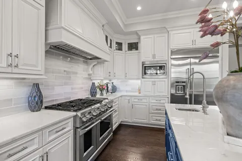 a stove top oven sitting inside of a kitchen