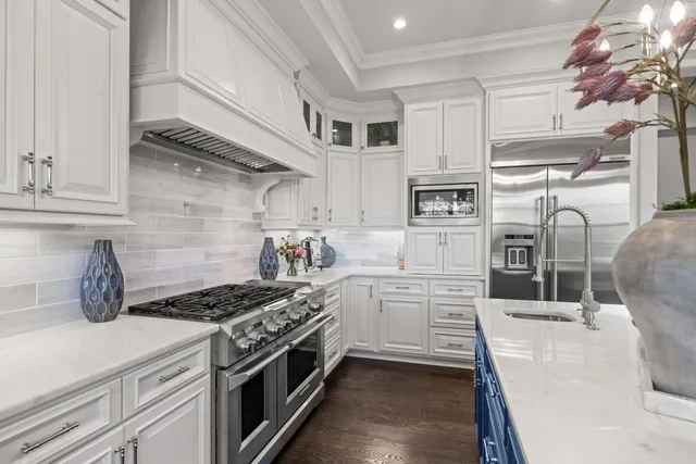 a stove top oven sitting inside of a kitchen