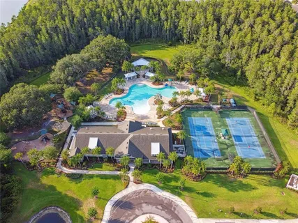 a view of a house with a yard and swimming pool