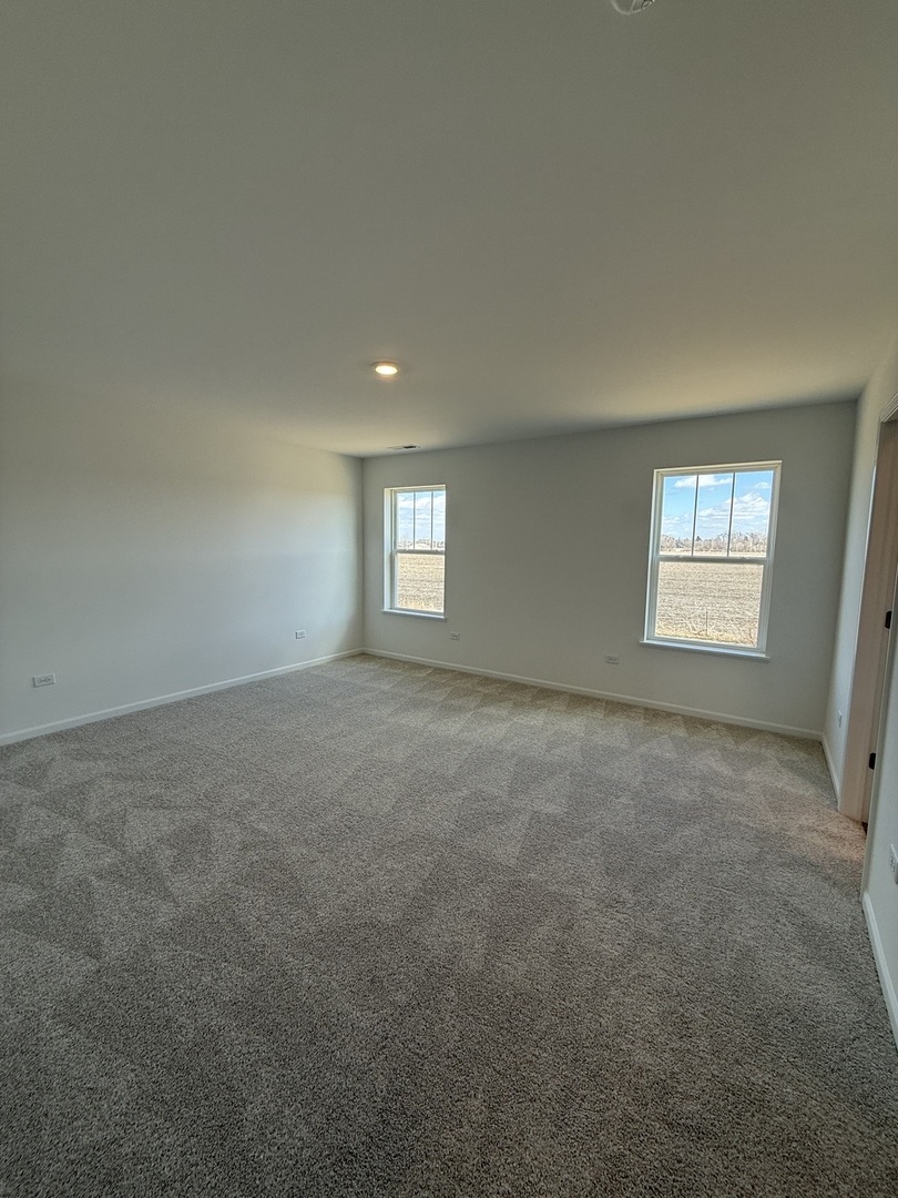 10232 McMahon Way, Unit 10232 Huntley, IL 60142 - Photo 12 of 22 a view of an empty room with a window