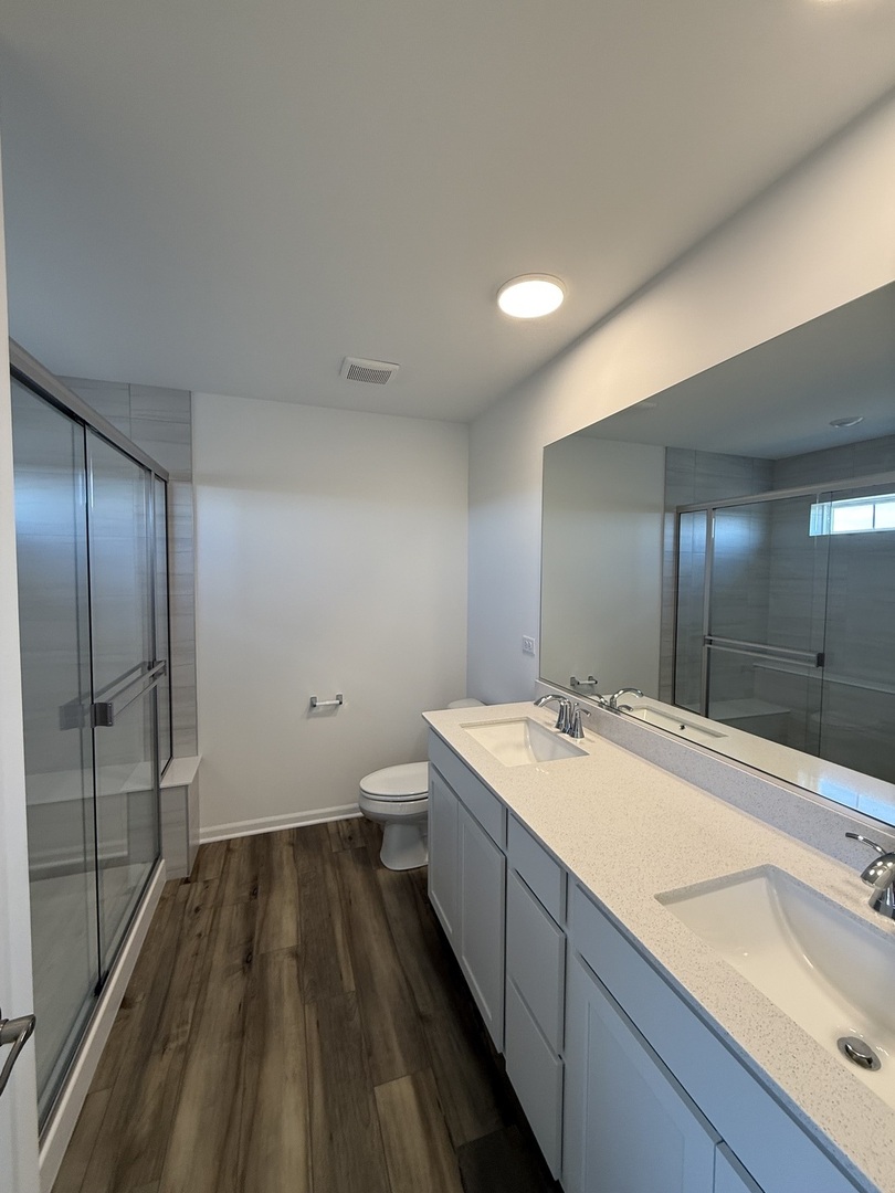 10232 McMahon Way, Unit 10232 Huntley, IL 60142 - Photo 13 of 22 a bathroom with a sink and mirror