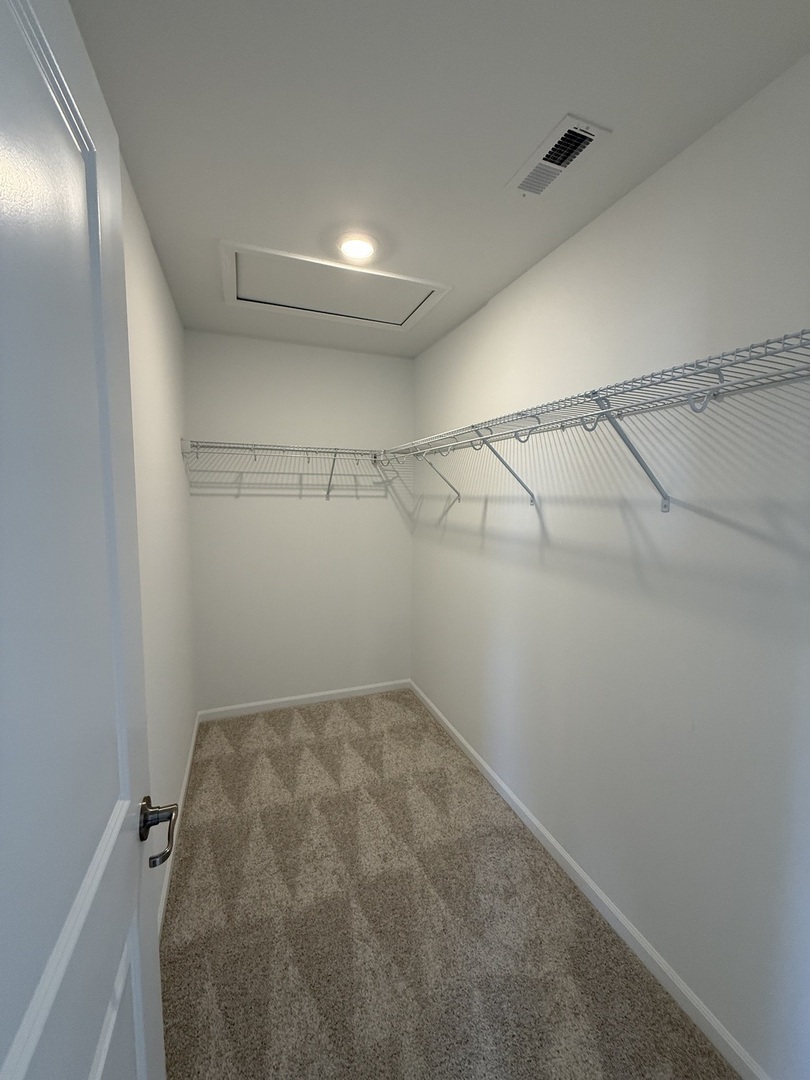 10232 McMahon Way, Unit 10232 Huntley, IL 60142 - Photo 15 of 22 a view of a room with racks on the wall