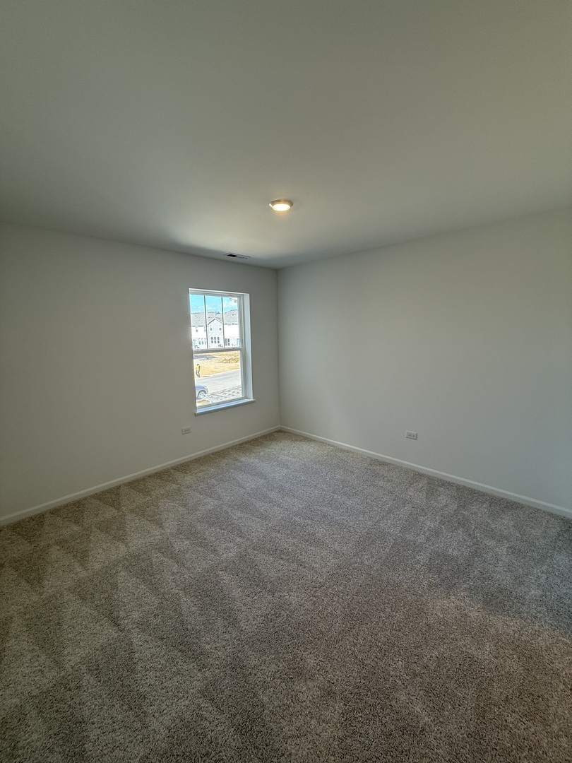 10232 McMahon Way, Unit 10232 Huntley, IL 60142 - Photo 17 of 22 an empty room with windows