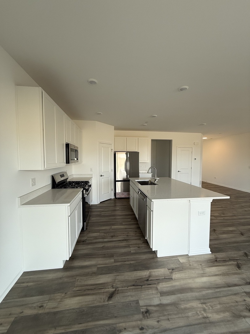 10232 McMahon Way, Unit 10232 Huntley, IL 60142 - Photo 5 of 22 a view of kitchen with wooden floor and electronic appliances