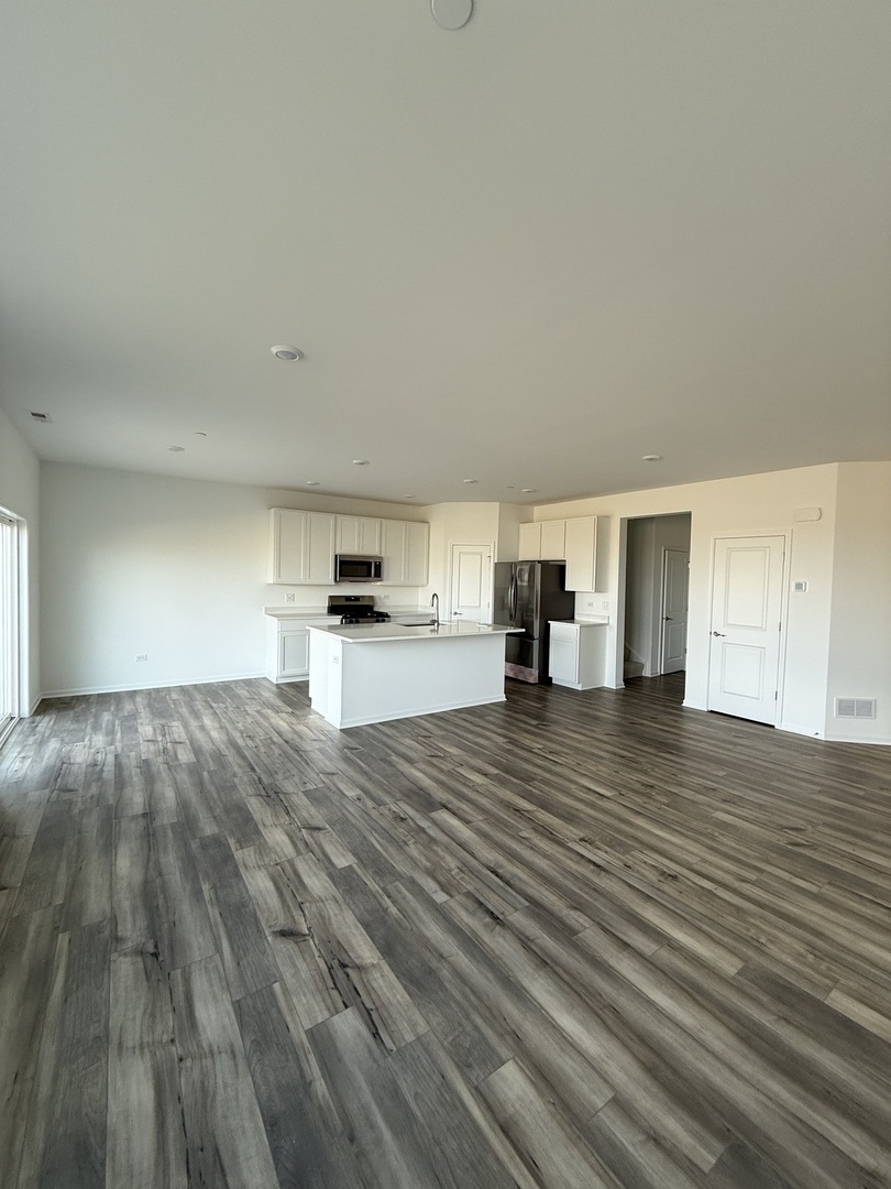 10232 McMahon Way, Unit 10232 Huntley, IL 60142 - Photo 6 of 22 a view of empty room with wooden floor