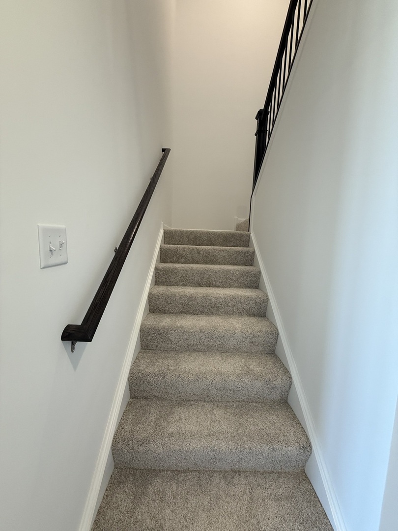 10232 McMahon Way, Unit 10232 Huntley, IL 60142 - Photo 9 of 22 a view of staircase with white walls