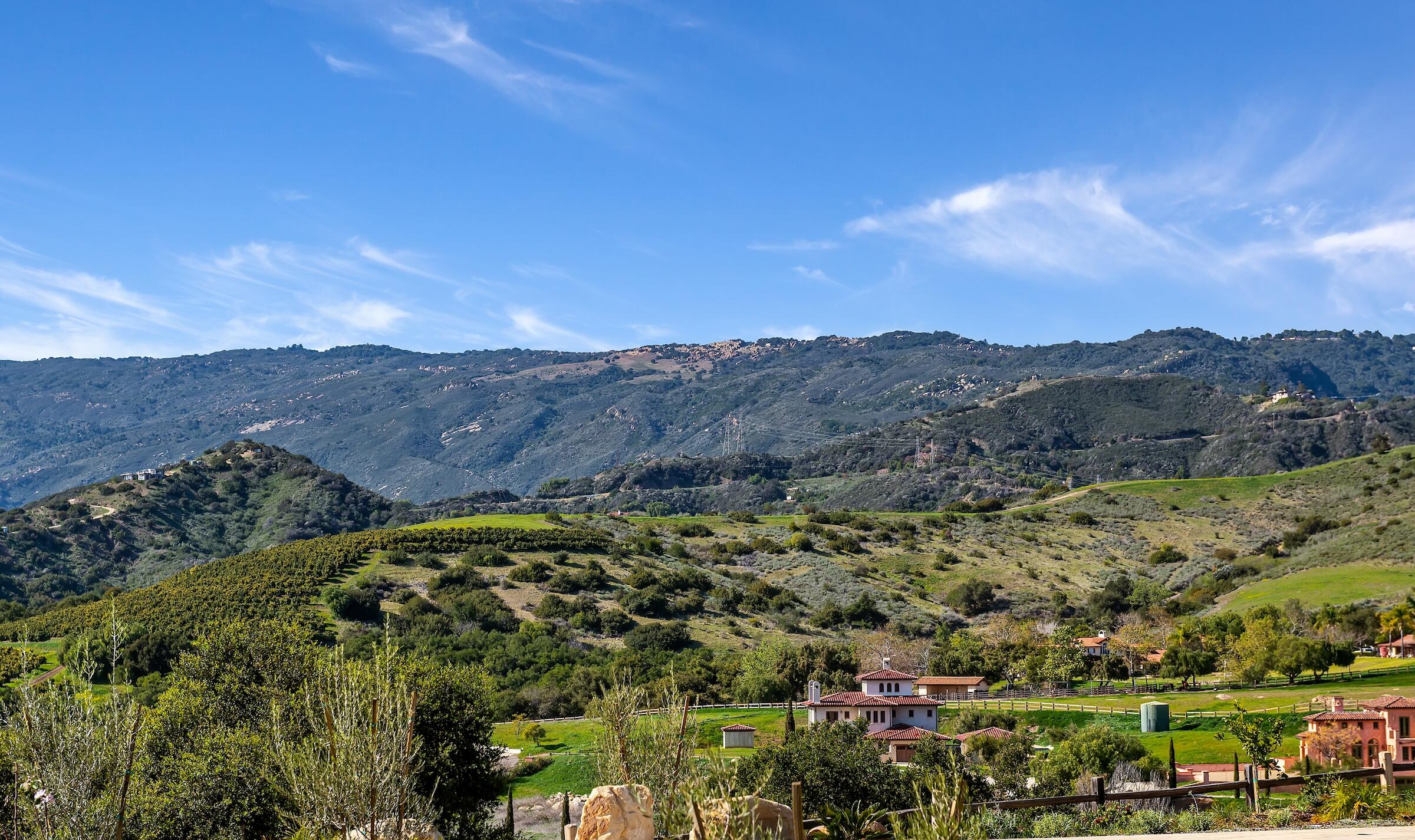 1367 Via Veneto Santa Barbara, CA 93111 - Photo 32 of 38 a view of a lush green field with mountains in the background