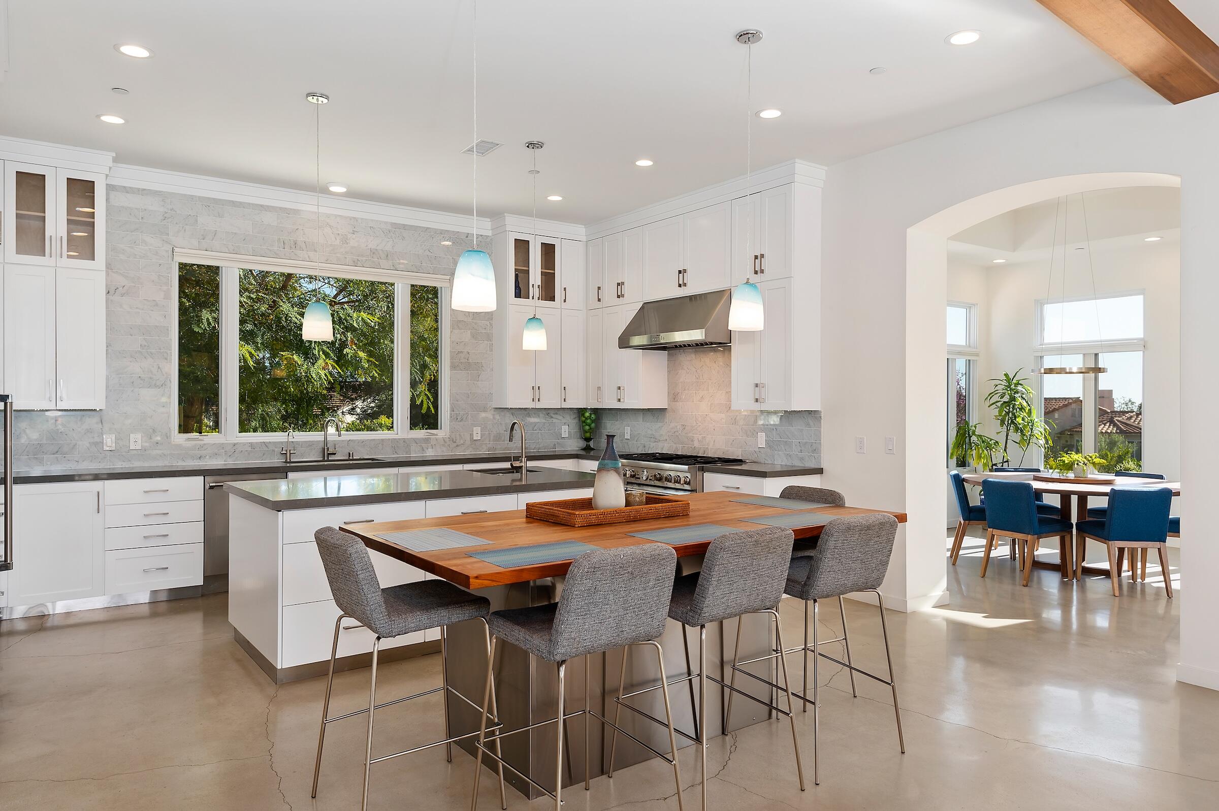 1367 Via Veneto Santa Barbara, CA 93111 - Photo 10 of 38 a kitchen with stainless steel appliances granite countertop a table and chairs in it