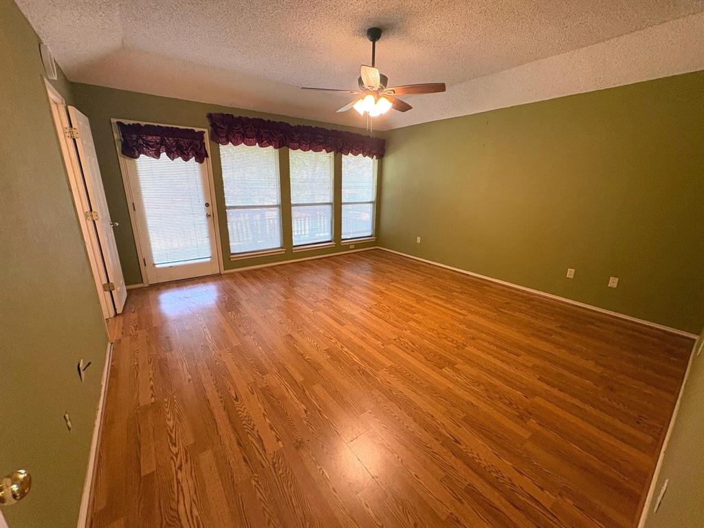 27 Sundown Trail Star Harbor, TX 75148 - Photo 14 of 32 wooden floor in an empty room with a window