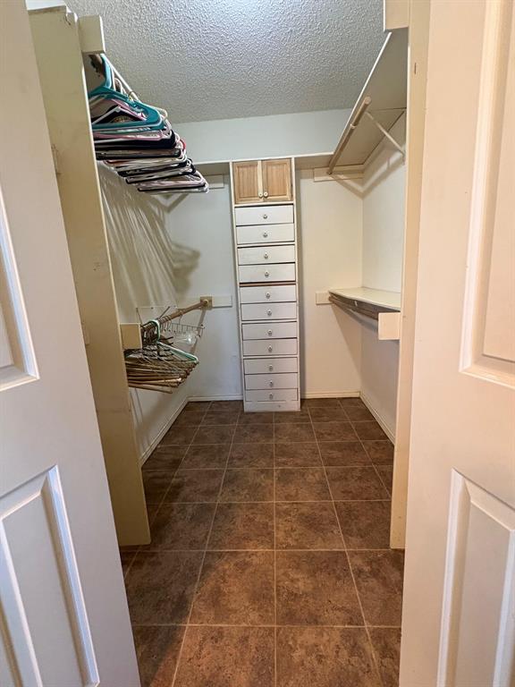 27 Sundown Trail Star Harbor, TX 75148 - Photo 19 of 32 a view of walk in closet with clothes and shoes