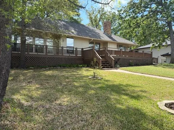 a front view of a house with a yard table and chairs