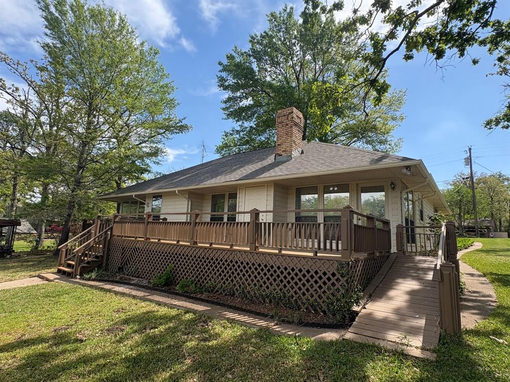 27 Sundown Trail Star Harbor, TX 75148 - Photo 24 of 32 a front view of a house with a yard table and chairs