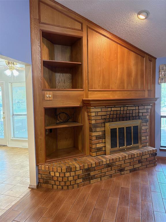 27 Sundown Trail Star Harbor, TX 75148 - Photo 7 of 32 a living room with a fireplace and wooden floor