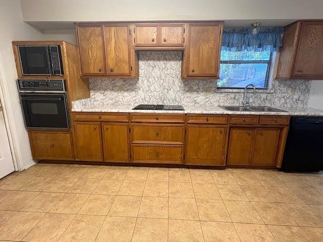 27 Sundown Trail Star Harbor, TX 75148 - Photo 9 of 32 a kitchen with granite countertop a stove a microwave and cabinets
