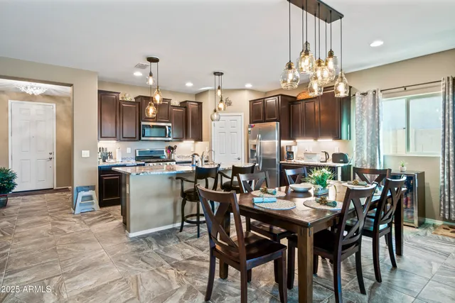 a view of a dining room with furniture and chandelier