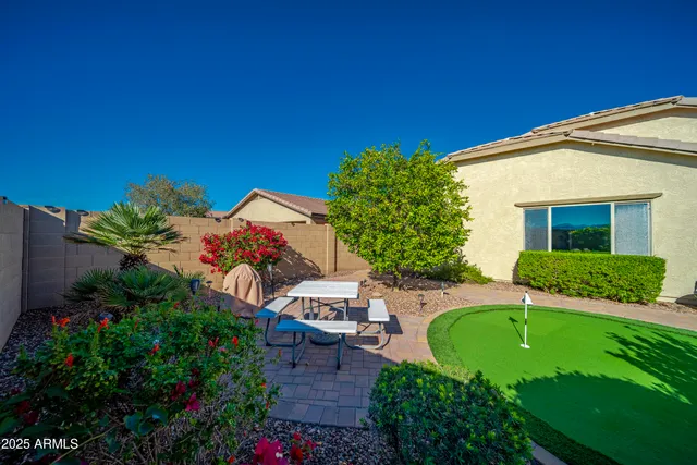a view of a house with a backyard