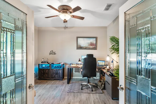 a view of a workspace with furniture and a window