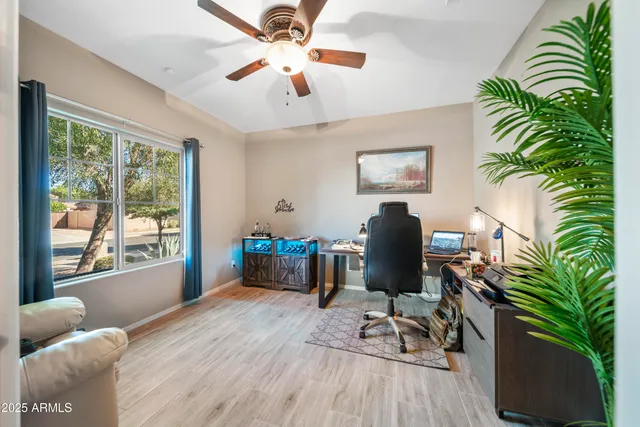 a work room with furniture and a potted plant
