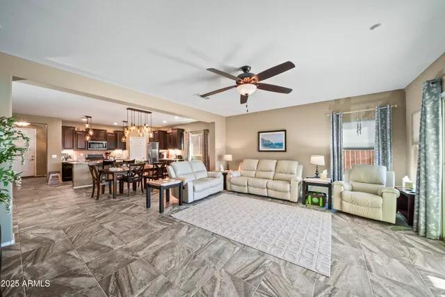 a living room with furniture and view of kitchen