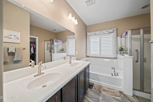 a bathroom with a tub sink and mirror