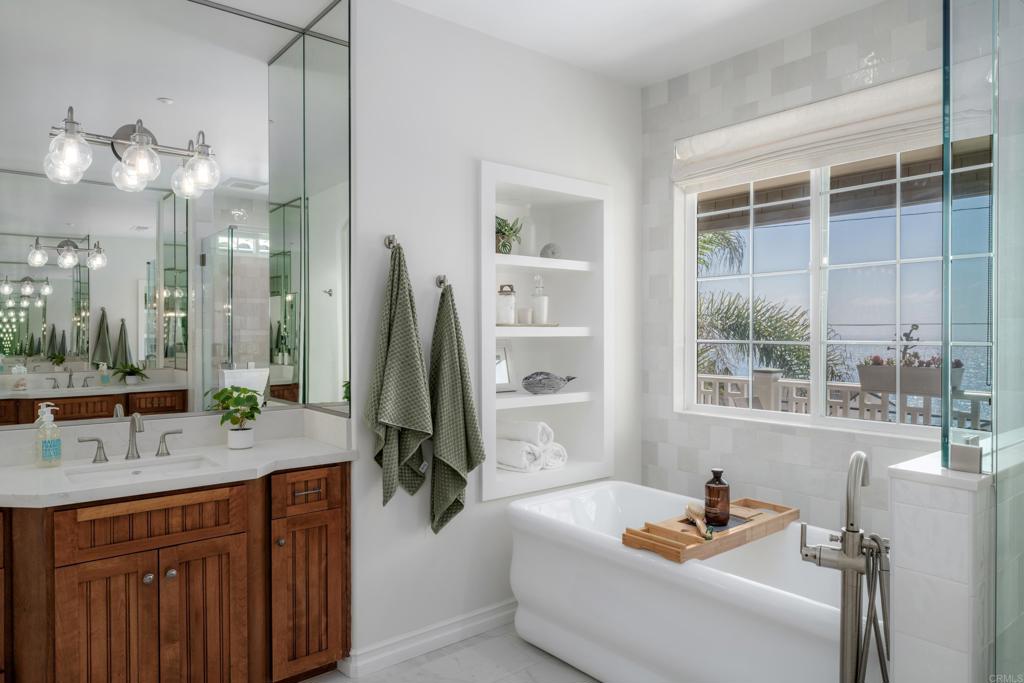 1483 Neptune Avenue Encinitas, CA 92024 - Photo 28 of 46 a bathroom with a tub sink and mirror