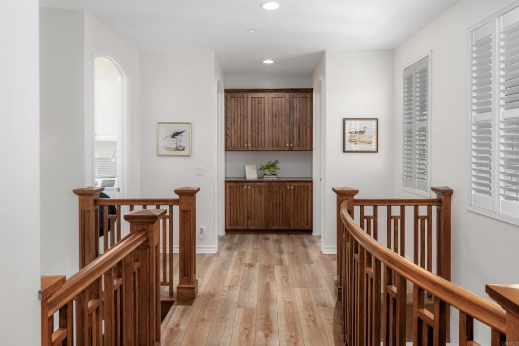 1483 Neptune Avenue Encinitas, CA 92024 - Photo 31 of 46 a view of a hallway with wooden floor and staircase