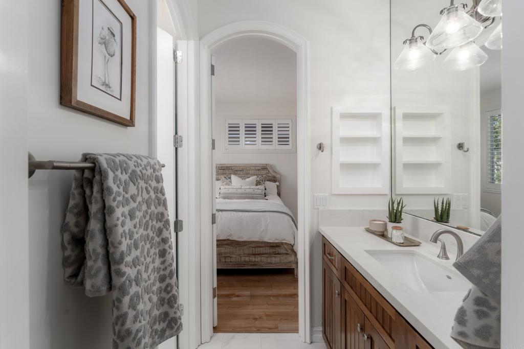 1483 Neptune Avenue Encinitas, CA 92024 - Photo 33 of 46 a en suite bathroom with a double vanity sink and a mirror