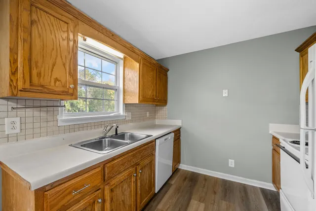 a kitchen that has a sink and a stove in it