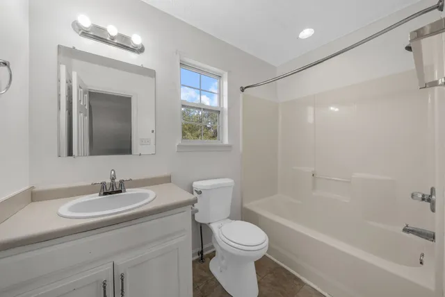 a bathroom with a toilet a sink and a mirror