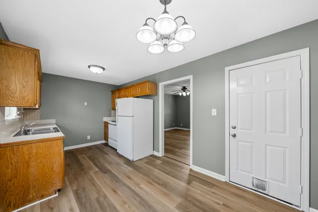 a view of a storage & utility room with closet wooden floor
