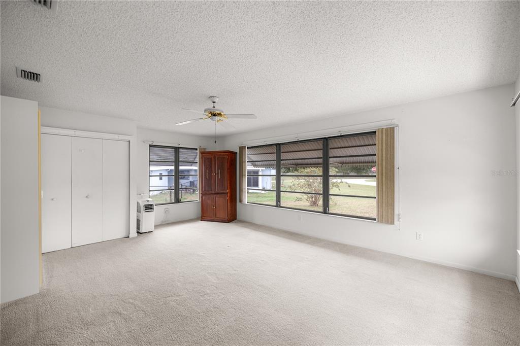 9230 Southwest 101st Lane Ocala, FL 34481 - Photo 14 of 31 a view of an empty room with a window and a kitchen